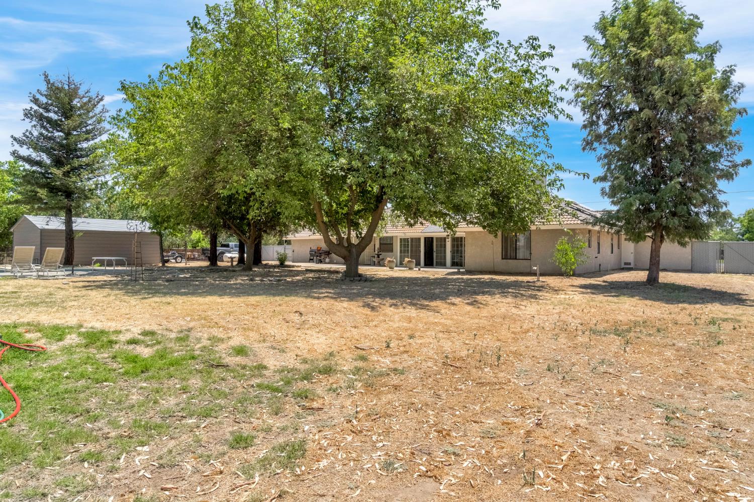 36065 Manon Avenue Madera, CA 93636 - Photo 40 of 50 a house with trees in front of it