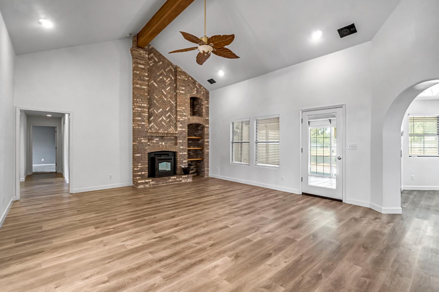 36065 Manon Avenue Madera, CA 93636 - Photo 4 of 50 a view of an empty room with a fireplace and a window