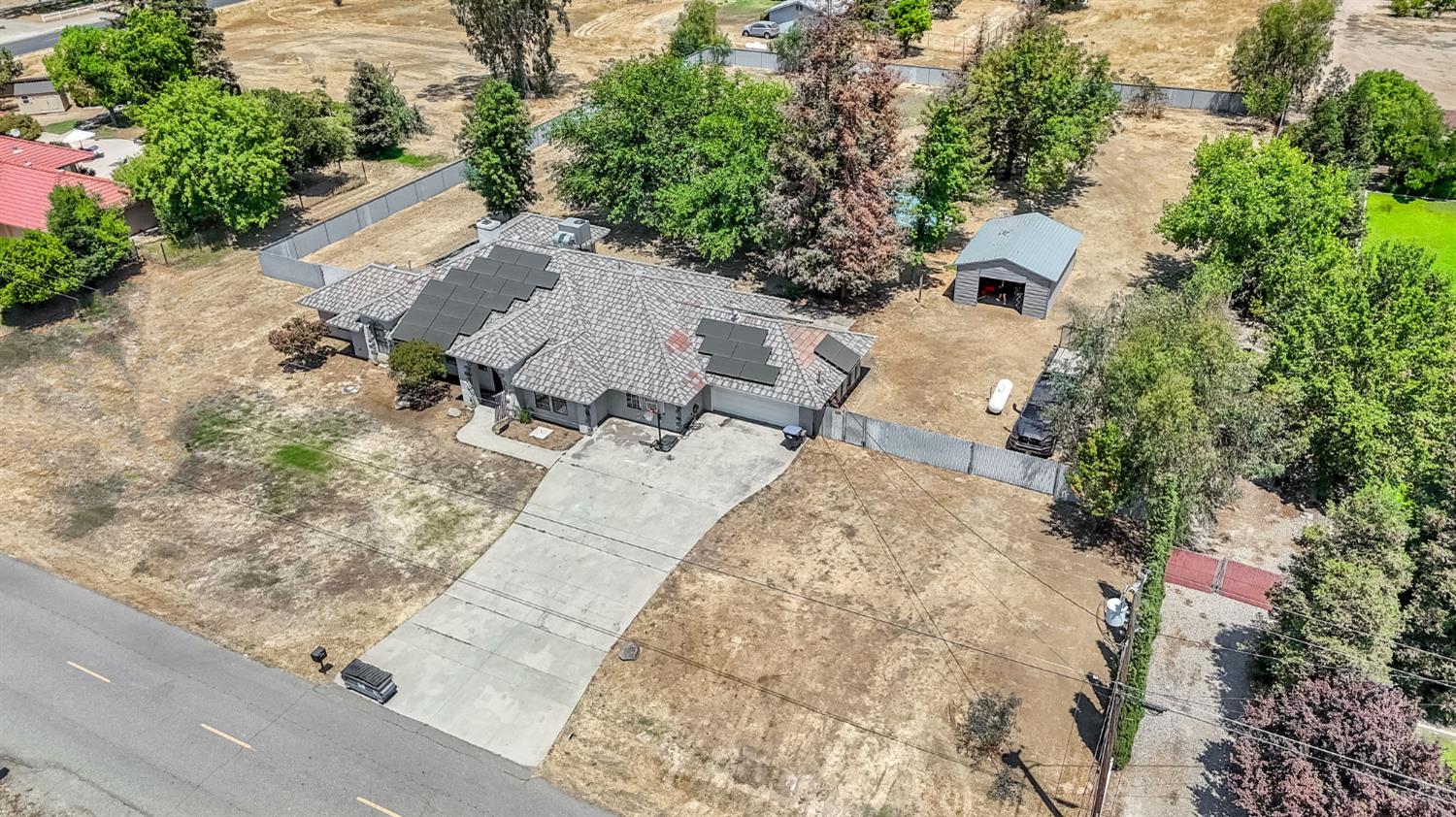 36065 Manon Avenue Madera, CA 93636 - Photo 45 of 50 an aerial view of a house with a yard and trees all around