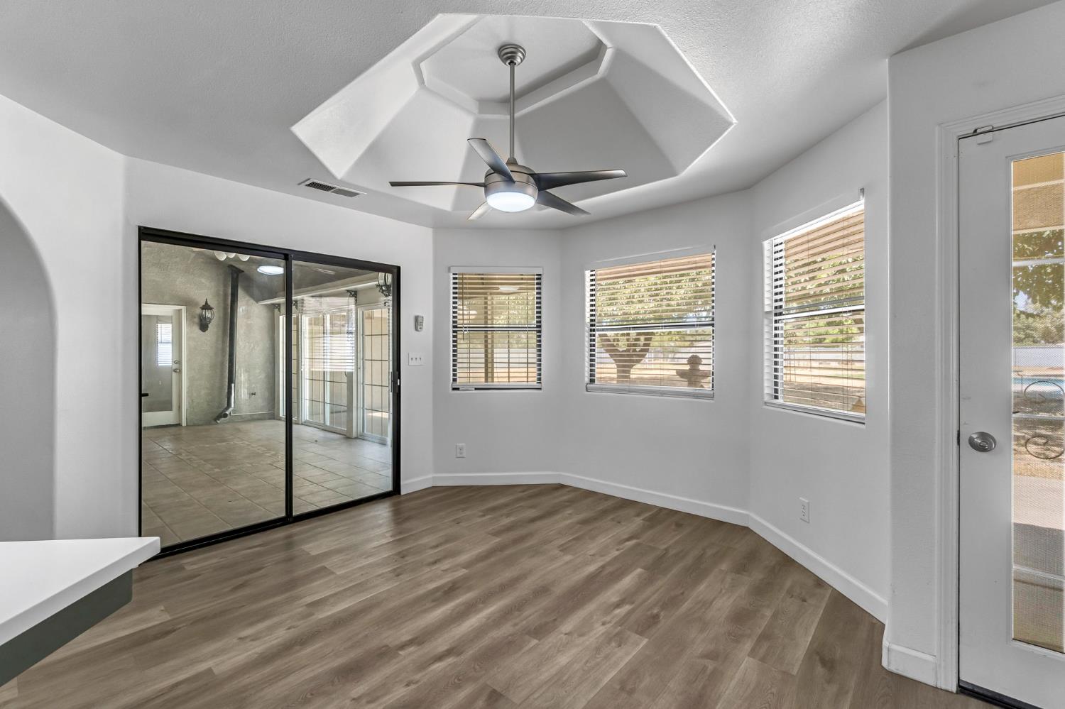 36065 Manon Avenue Madera, CA 93636 - Photo 8 of 50 a view of an empty room with a window and wooden floor