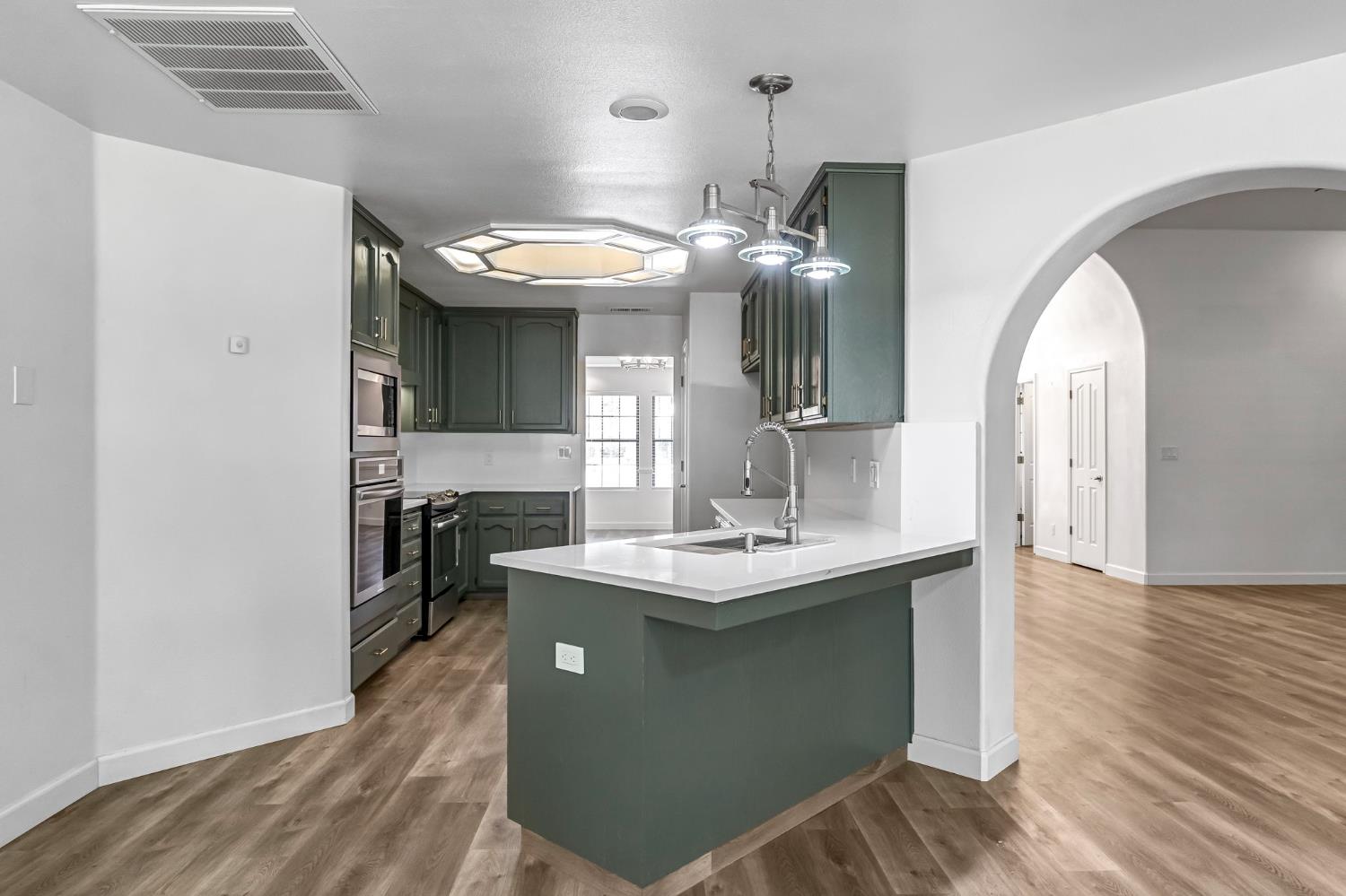 36065 Manon Avenue Madera, CA 93636 - Photo 9 of 50 a kitchen with a sink and a mirror