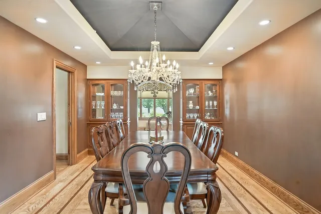 a living room with furniture cabinets and a large window