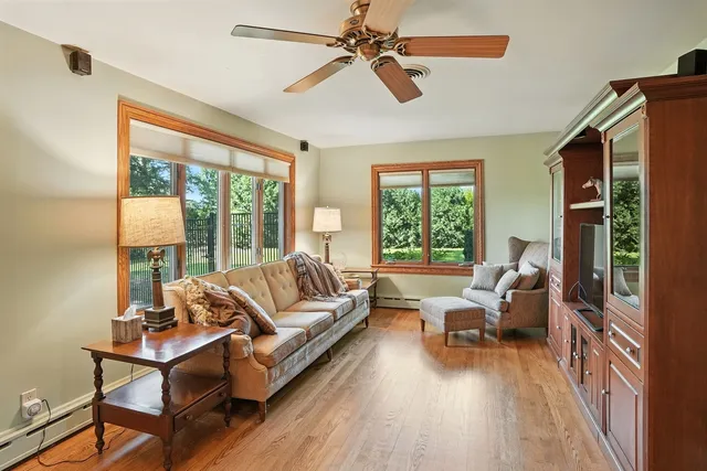 a view of a hallway with wooden floor and windows