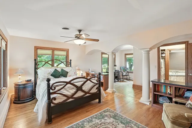 a spacious bathroom with a granite countertop sink and a large mirror