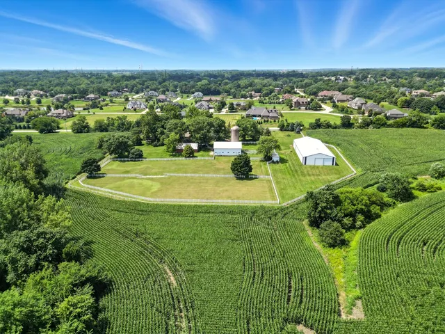 a kitchen with stainless steel appliances granite countertop a sink refrigerator and cabinets