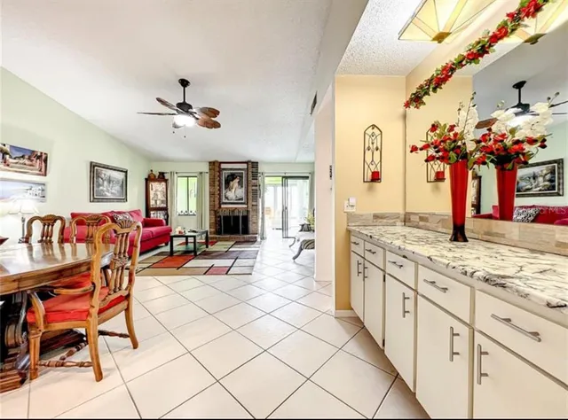 a living room with stainless steel appliances kitchen island granite countertop furniture and a kitchen view