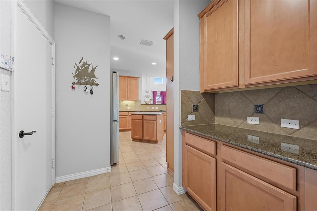11577 Mansfield Drive Frisco, TX 75035 - Photo 14 of 37 a kitchen with cabinets and window