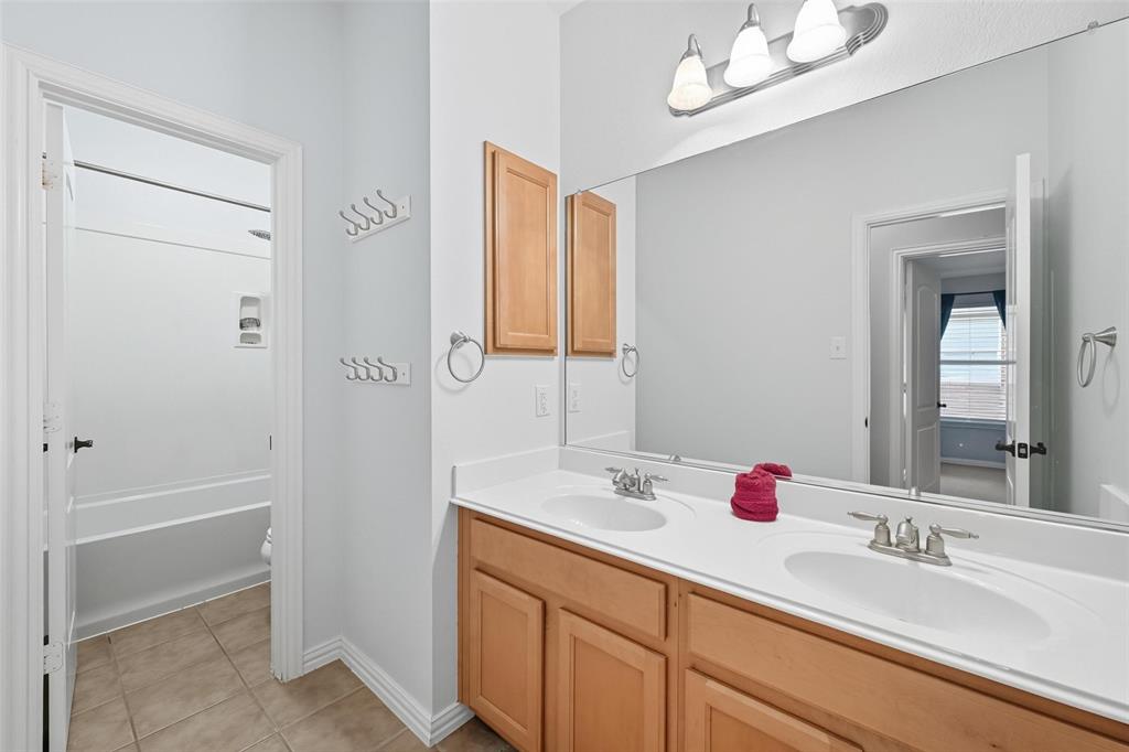 11577 Mansfield Drive Frisco, TX 75035 - Photo 27 of 37 a bathroom with a sink vanity and a mirror