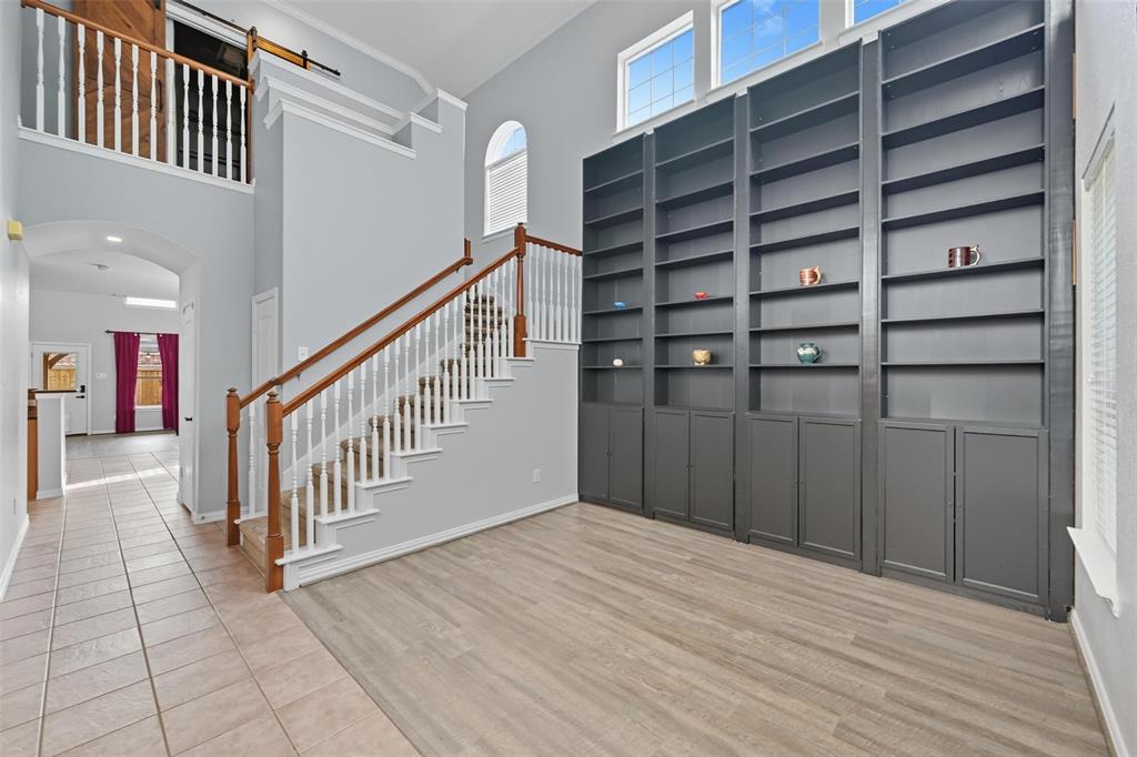 11577 Mansfield Drive Frisco, TX 75035 - Photo 4 of 37 a view of a hallway with wooden floor and stairs