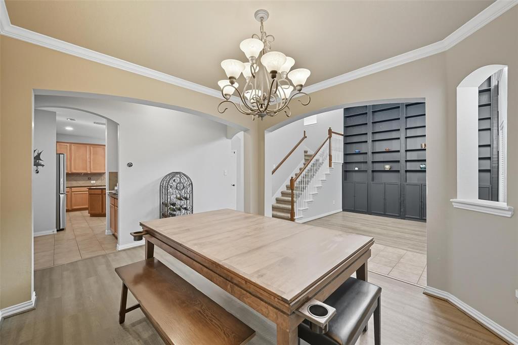 11577 Mansfield Drive Frisco, TX 75035 - Photo 7 of 37 a view of a dining room with furniture and wooden floor