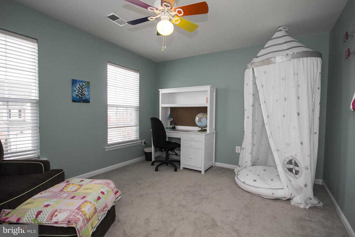 2044 Myrtlewood Road Baltimore, MD 21209 - Photo 22 of 30 a bedroom with a bed and a chandelier