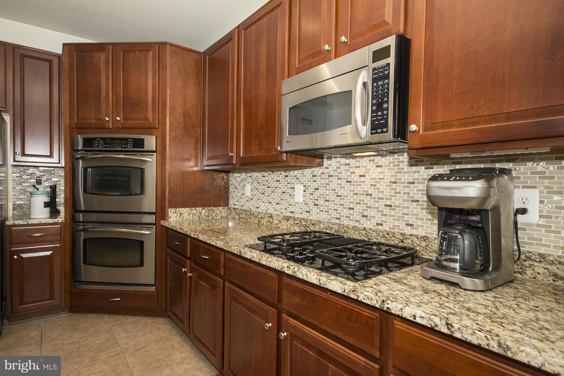 2044 Myrtlewood Road Baltimore, MD 21209 - Photo 8 of 30 a kitchen with granite countertop a stove and a microwave