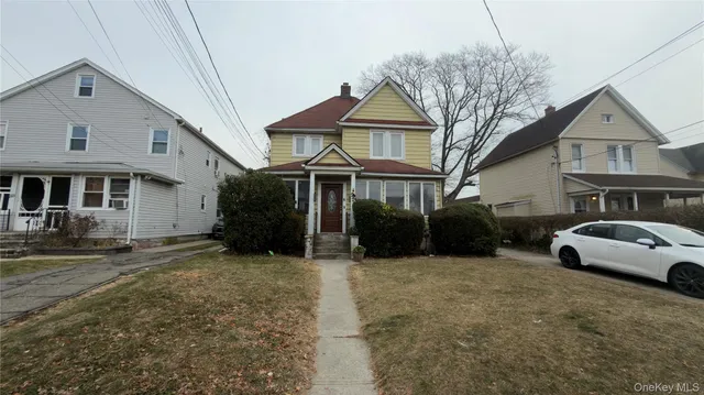 a front view of a house with a yard