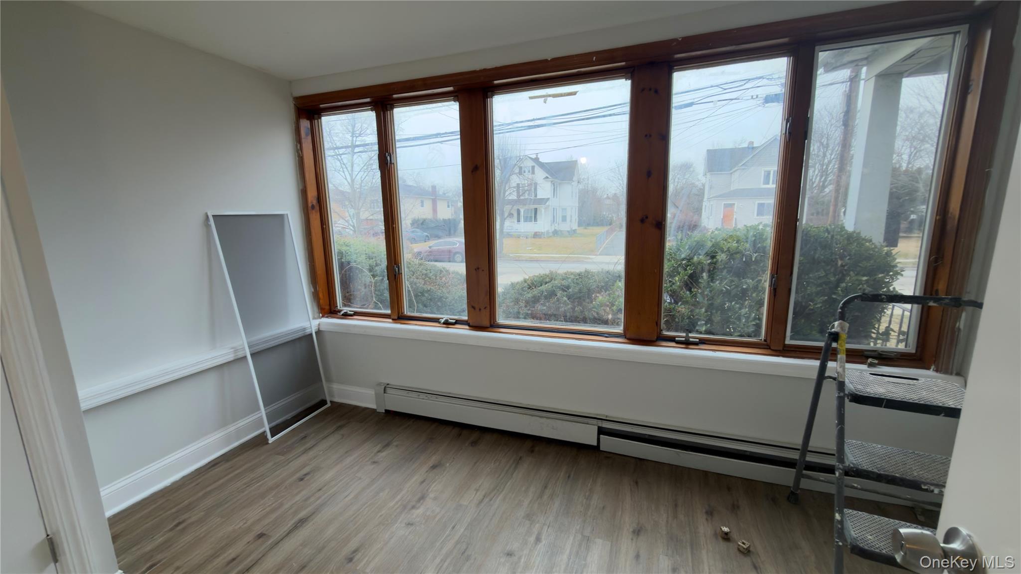 225 Church Street, Unit 2 Freeport, NY 11520 - Photo 18 of 18 a view of an empty room with wooden floor and a window