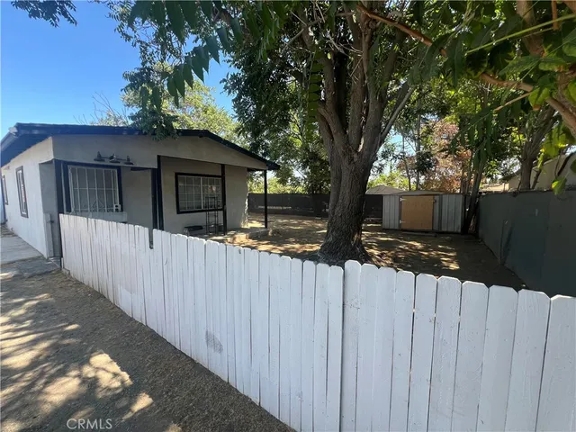 a front view of a house with a wooden fence