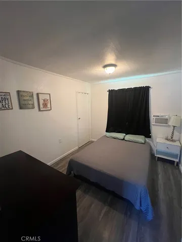a bedroom with a bed and a chair