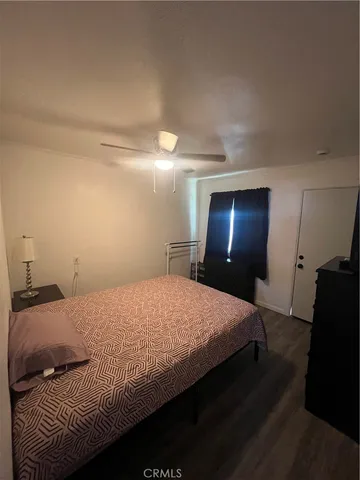 a bedroom with a bed and a mirror