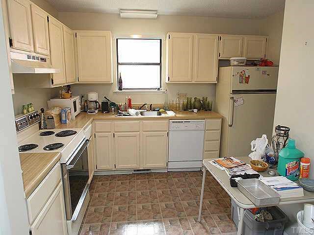 5416 Ridgeloch Place Raleigh, NC 27612 - Photo 2 of 5 a kitchen with a stove a sink and a refrigerator