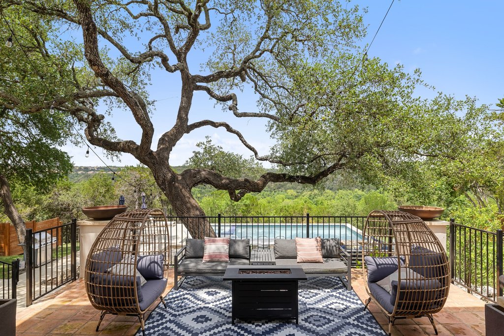 716 North Commons Ford Road Austin, TX 78733 - Photo 22 of 30 Spacious outdoor patio featuring terracotta-style flooring, a black metal railing, and a built-in pool