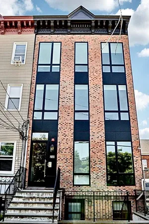 a view of a wooden door with a small yard