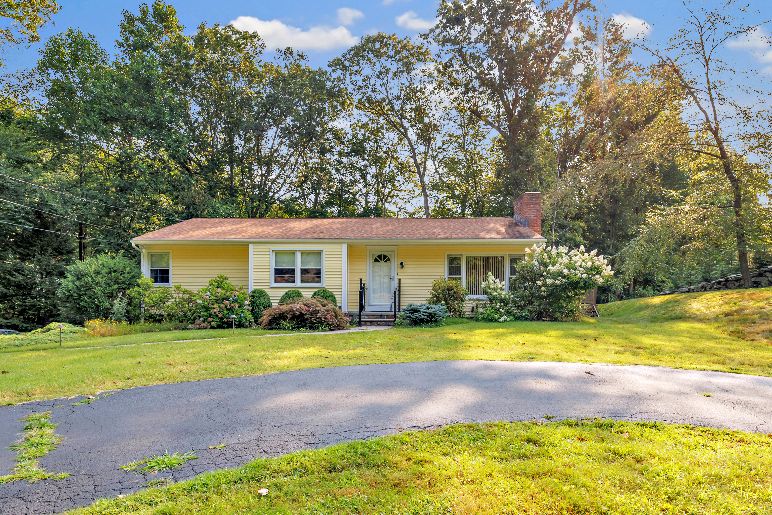 a front view of a house with swimming pool and yard