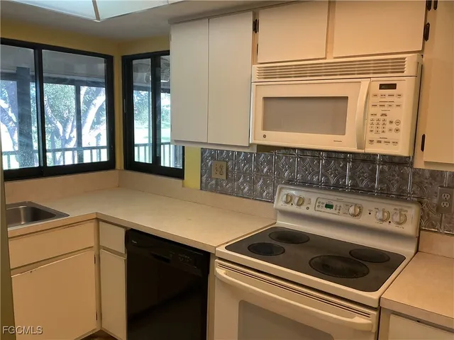a view of a refrigerator in kitchen and wooden floor