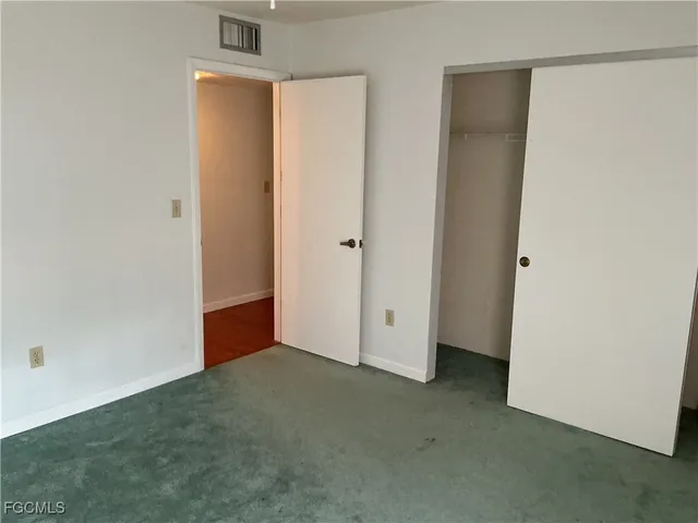 a view of a livingroom with a ceiling fan and window