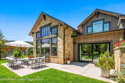 a view of a house with backyard porch and sitting area