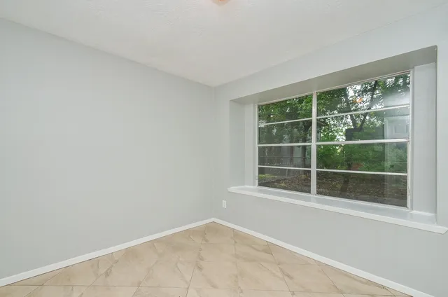 a view of an empty room with a window