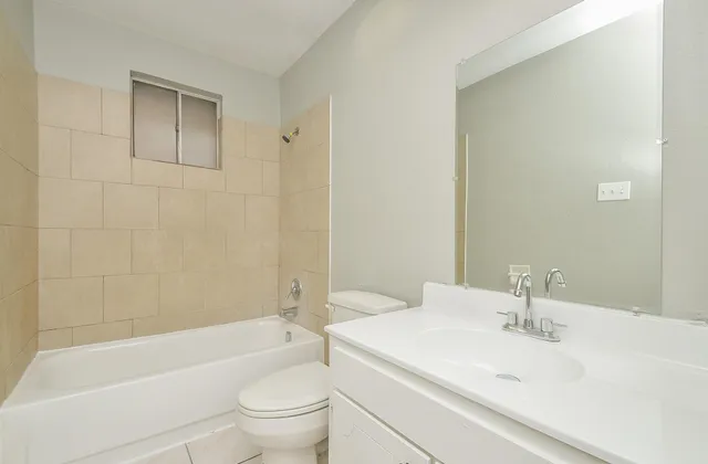 a bathroom with a sink a toilet and a bathtub