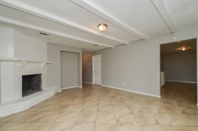 a view of an empty room with a fireplace
