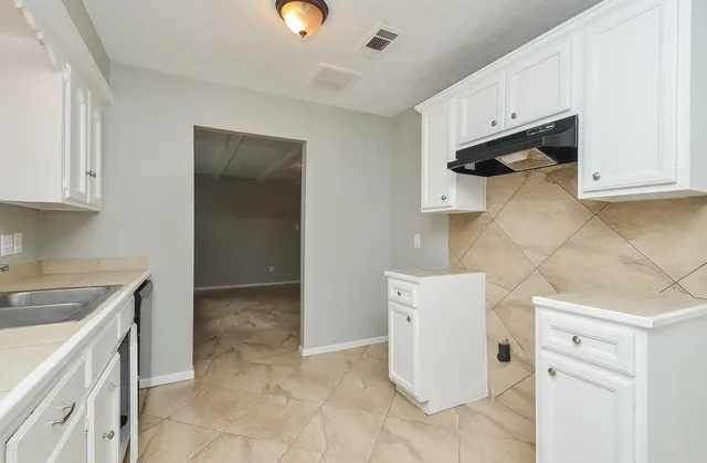 a kitchen with a sink and cabinets