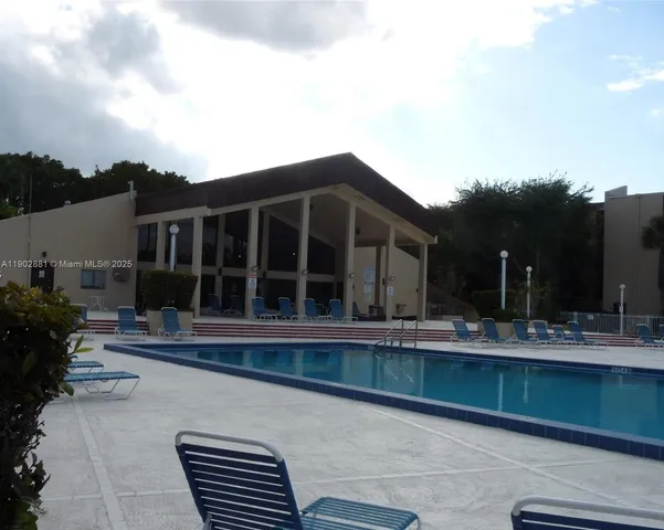 a view of house with a yard and sitting space
