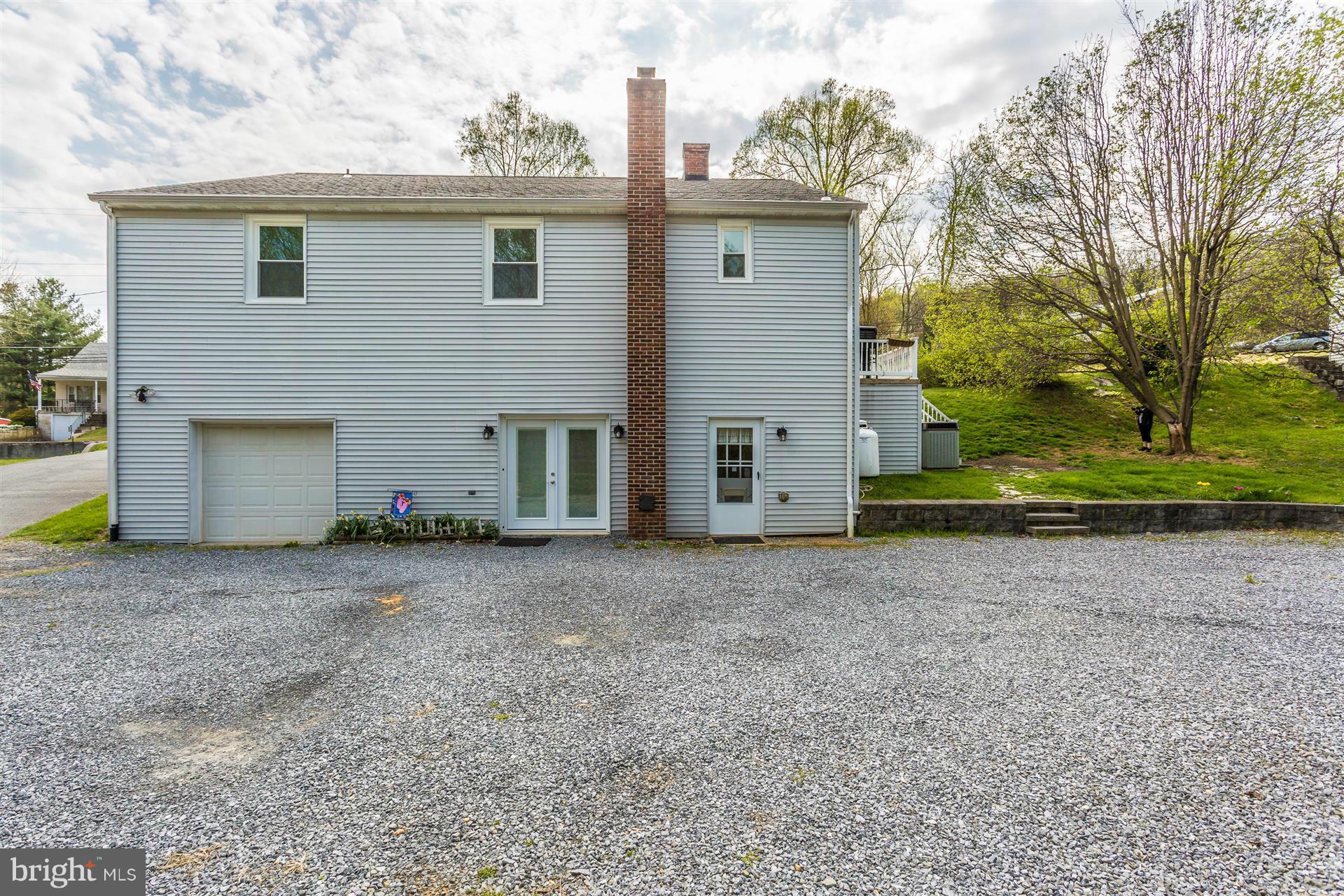 4834 Old Swimming Pool Road Frederick, MD 21703 - Photo 19 of 27 a view of a house with a yard and garage