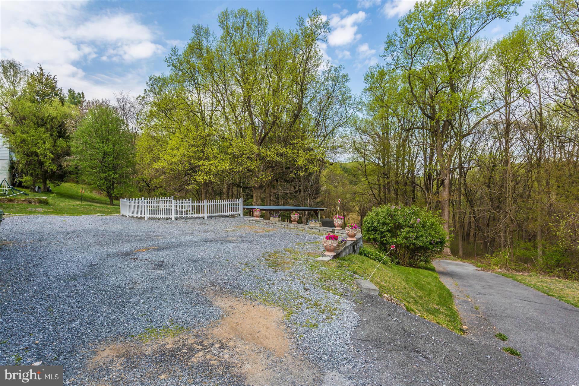 4834 Old Swimming Pool Road Frederick, MD 21703 - Photo 24 of 27 a view of a backyard with large trees