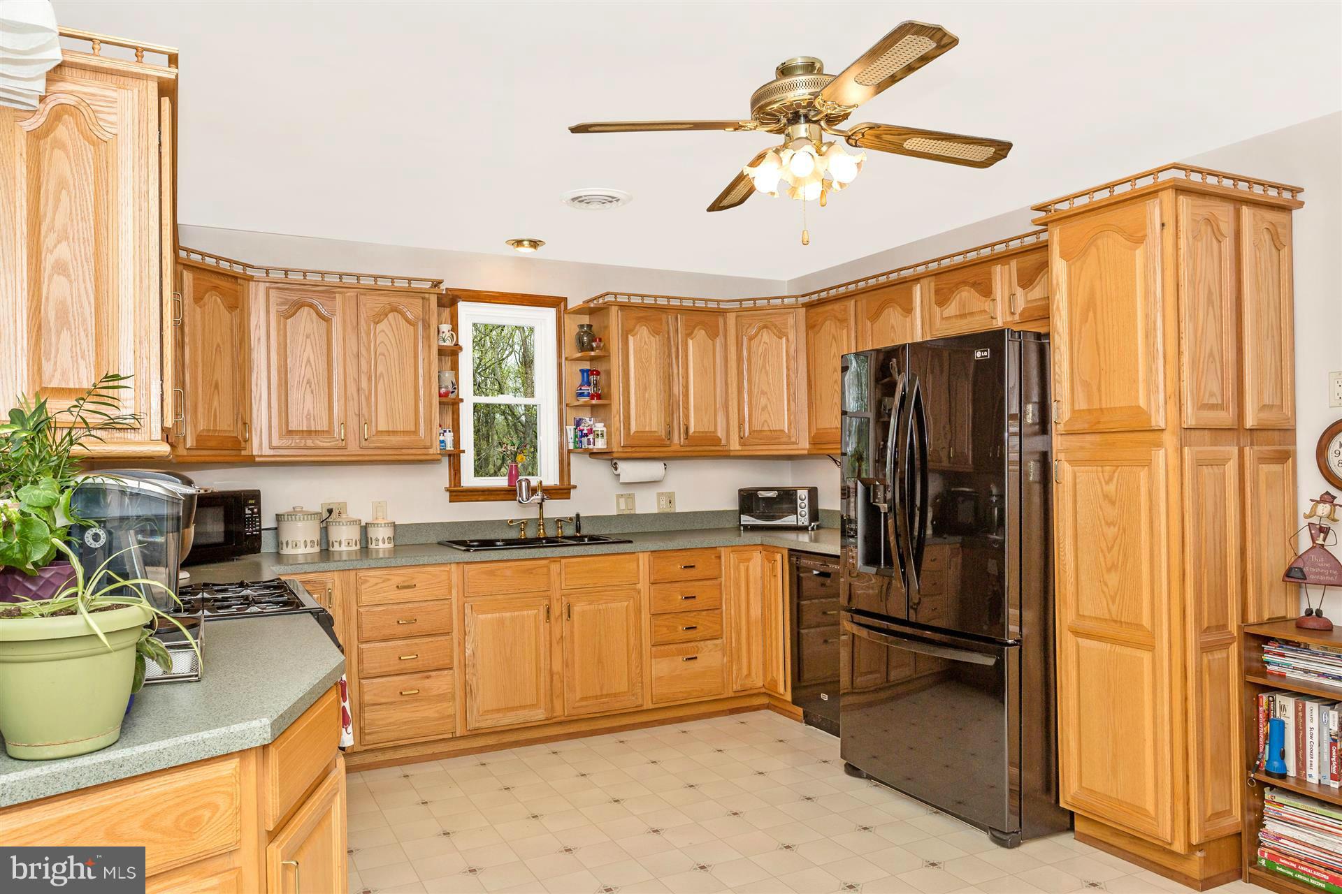 4834 Old Swimming Pool Road Frederick, MD 21703 - Photo 4 of 27 a kitchen with a refrigerator a sink and cabinets