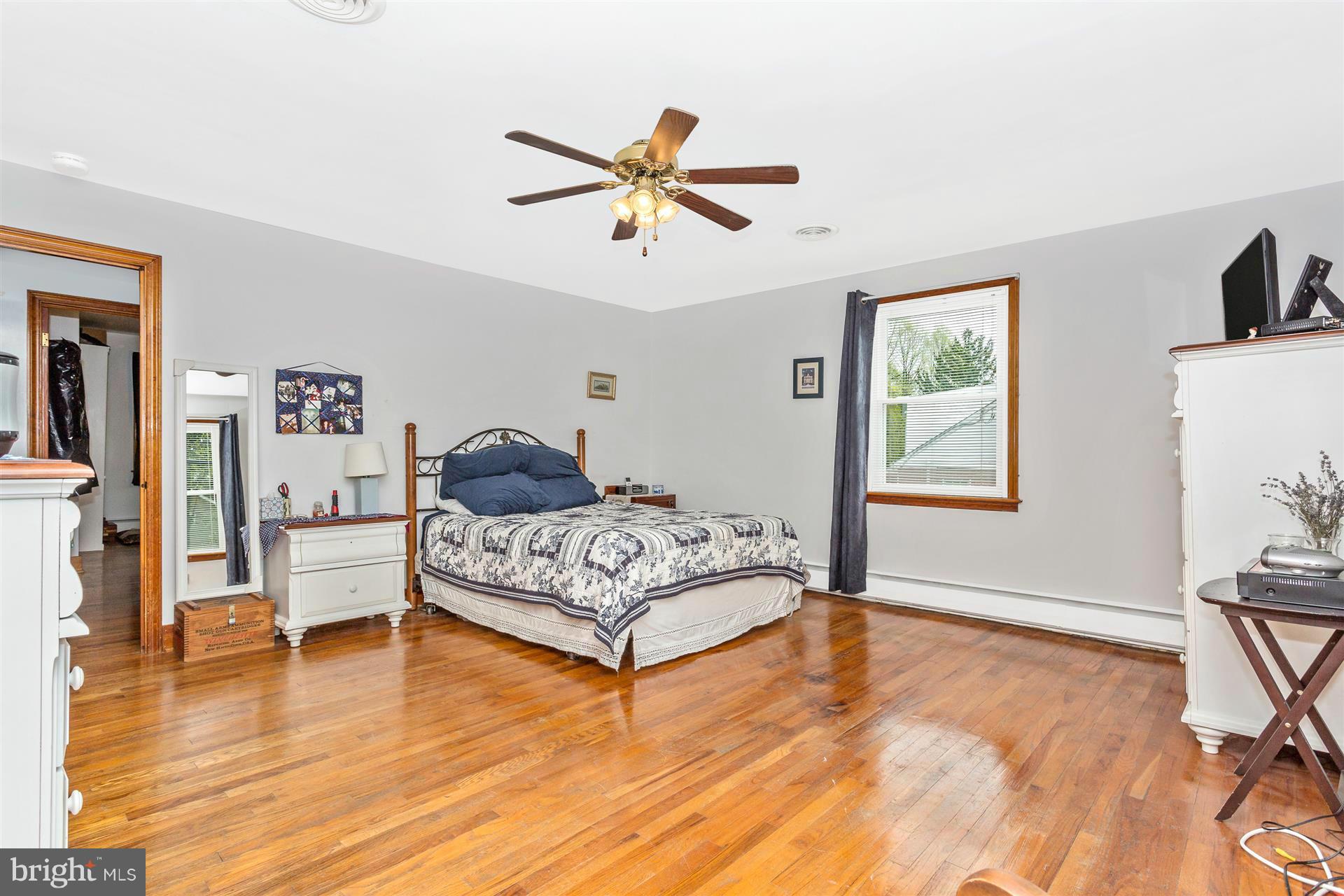 4834 Old Swimming Pool Road Frederick, MD 21703 - Photo 10 of 27 a bedroom with a bed and wooden floor
