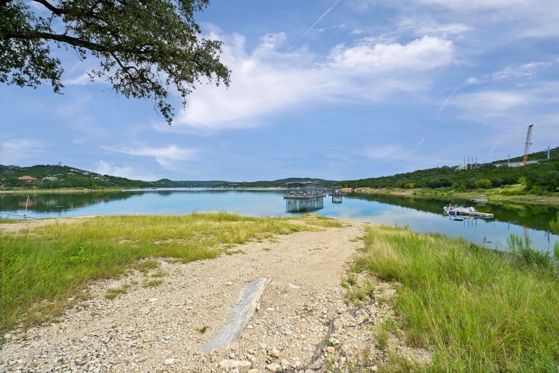 9006 Lime Creek Road Leander, TX 78641 - Photo 7 of 18 a view of a lake with a house in the background