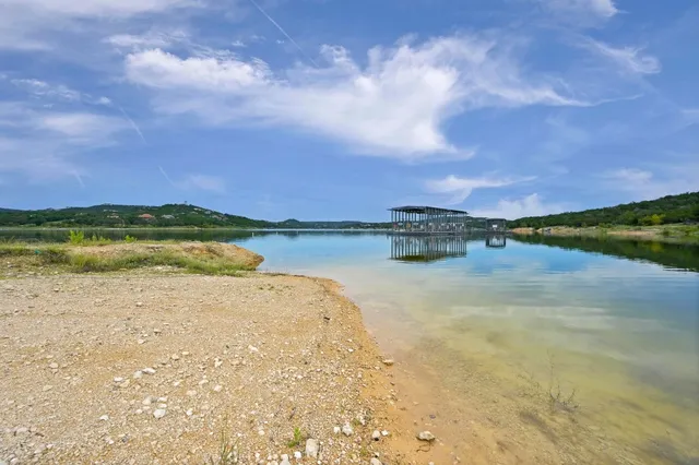 a view of a lake with houses in the background