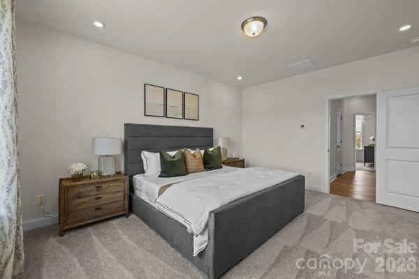 a bedroom with a bed and a view of bathroom