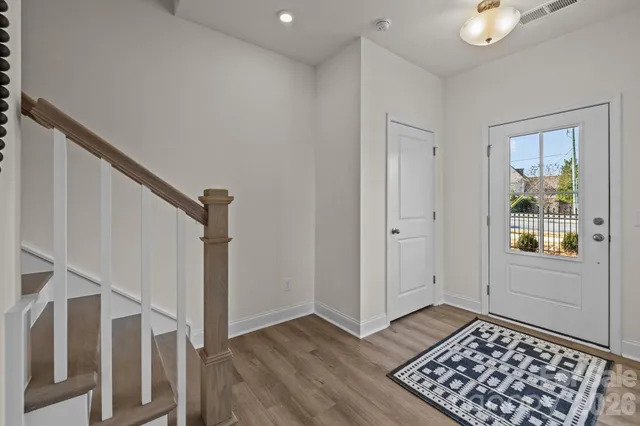a view of an entryway with wooden floor