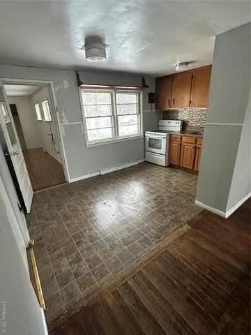 a kitchen with granite countertop a stove a sink and a microwave