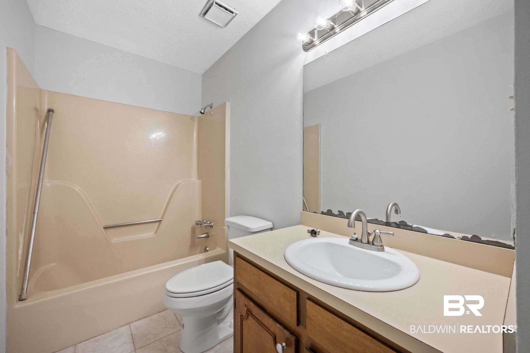 3701 Vista Ridge Drive Mobile, AL 36693 - Photo 26 of 33 Full bathroom with shower / bathtub combination, a textured ceiling, tile patterned flooring, vanity, and toilet