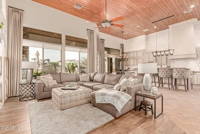 a kitchen with stainless steel appliances a table and chairs in it