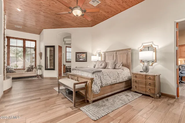 a spacious bedroom with a bed and furniture