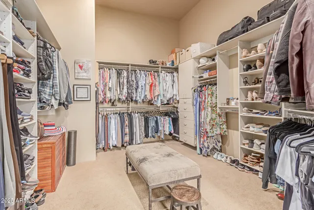 a room with chandelier fan and windows