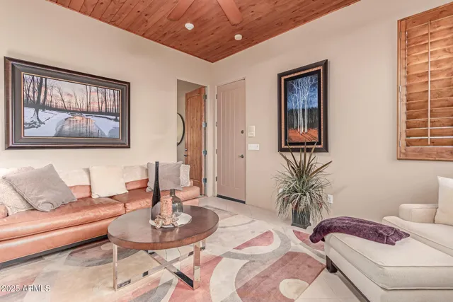 an aerial view of residential houses with a street and green space