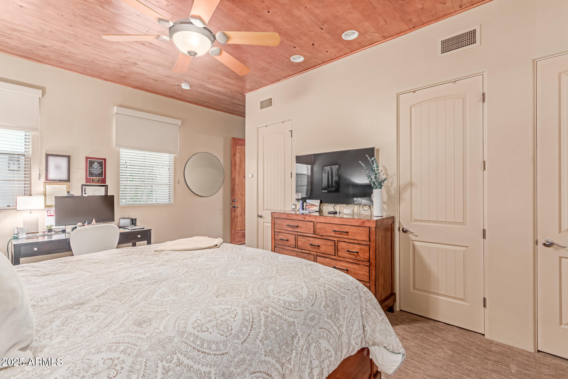 4317 North Brighton Circle Mesa, AZ 85207 - Photo 44 of 76 a bedroom with a bed a flat screen tv and dresser