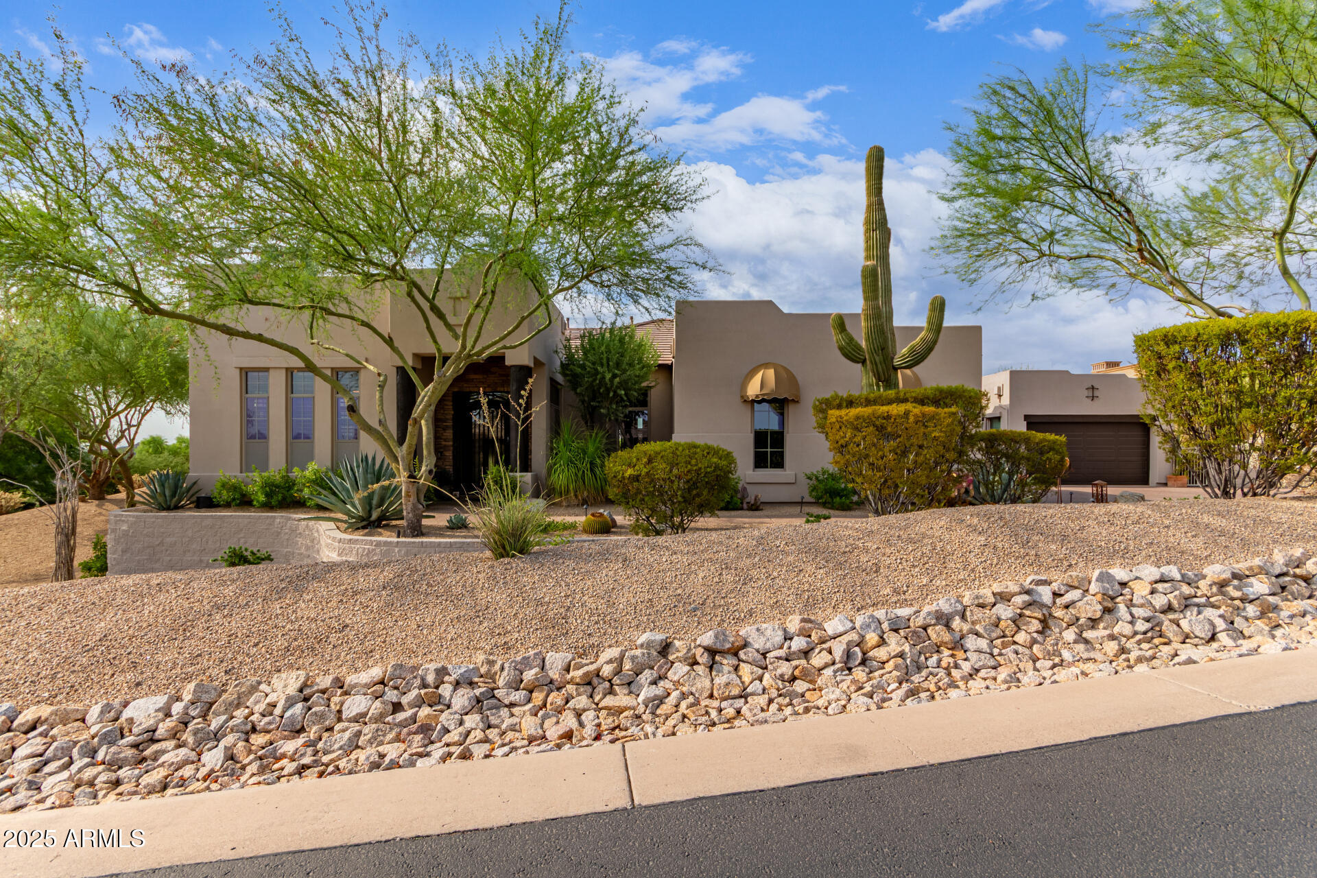 4317 North Brighton Circle Mesa, AZ 85207 - Photo 5 of 76 a front view of a house with a yard and garage