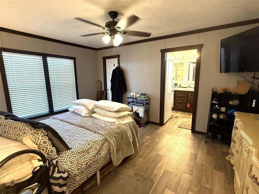 12703 Farm To Market 59 Athens, TX 75751 - Photo 30 of 40 a bedroom with a bed and a flat screen tv